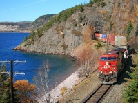 Snaking around Lake Superior's Nipigon Bay on a fine fall afternoon, Vancouver to Montreal's St. Luc train 112, with CP 8577 and mid-train DPU CP 9607, exits Cavers Tunnel at mile 27 on the CP's Nipigon Sub.