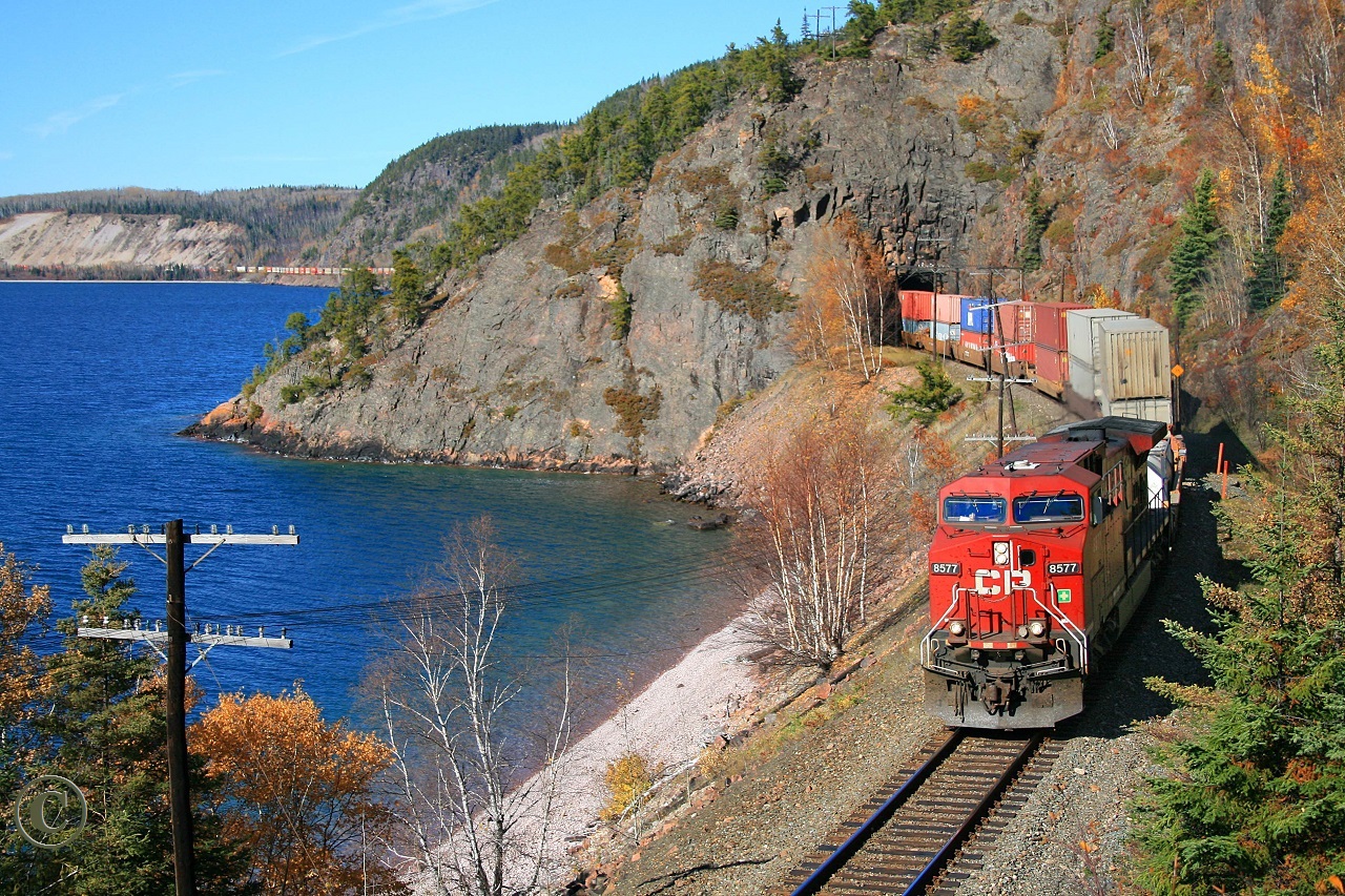 Snaking around Lake Superior's Nipigon Bay on a fine fall afternoon, Vancouver to Montreal's St. Luc train 112, with CP 8577 and mid-train DPU CP 9607, exits Cavers Tunnel at mile 27 on the CP's Nipigon Sub.