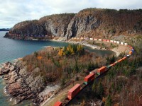 CP 8870, already around the curve in the upper left of the frame, and DPU CP 8637 on the fill centre left, lead Montreal's St. Luc to Coquitlam train 113 around Lake Superior's Mink Harbor and through Mink Tunnel at mile 72.9 on the CP's Heron Bay Sub.