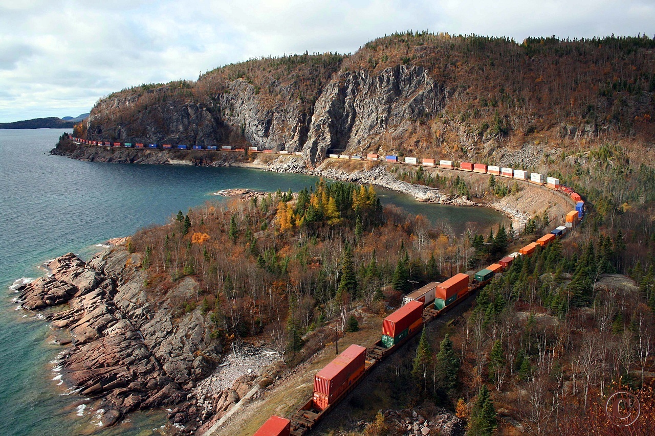 CP 8870, already around the curve in the upper left of the frame, and DPU CP 8637 on the fill centre left, lead Montreal's St. Luc to Coquitlam train 113 around Lake Superior's Mink Harbor and through Mink Tunnel at mile 72.9 on the CP's Heron Bay Sub.