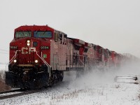 424 kicks up some snow as it is passing 39th Line with CP 9584 - CP 9532 - CP 5736 - CP 6047 - CP 5739 - CP 5688 