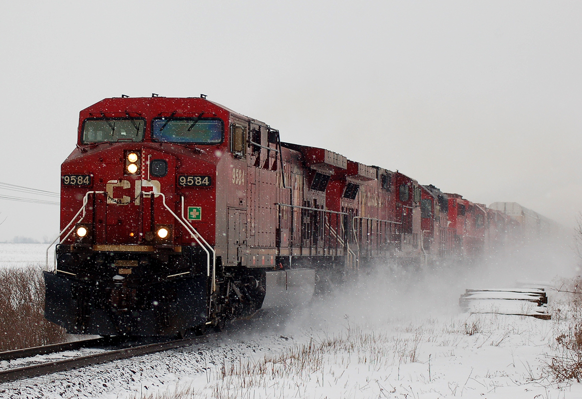 424 kicks up some snow as it is passing 39th Line with CP 9584 - CP 9532 - CP 5736 - CP 6047 - CP 5739 - CP 5688