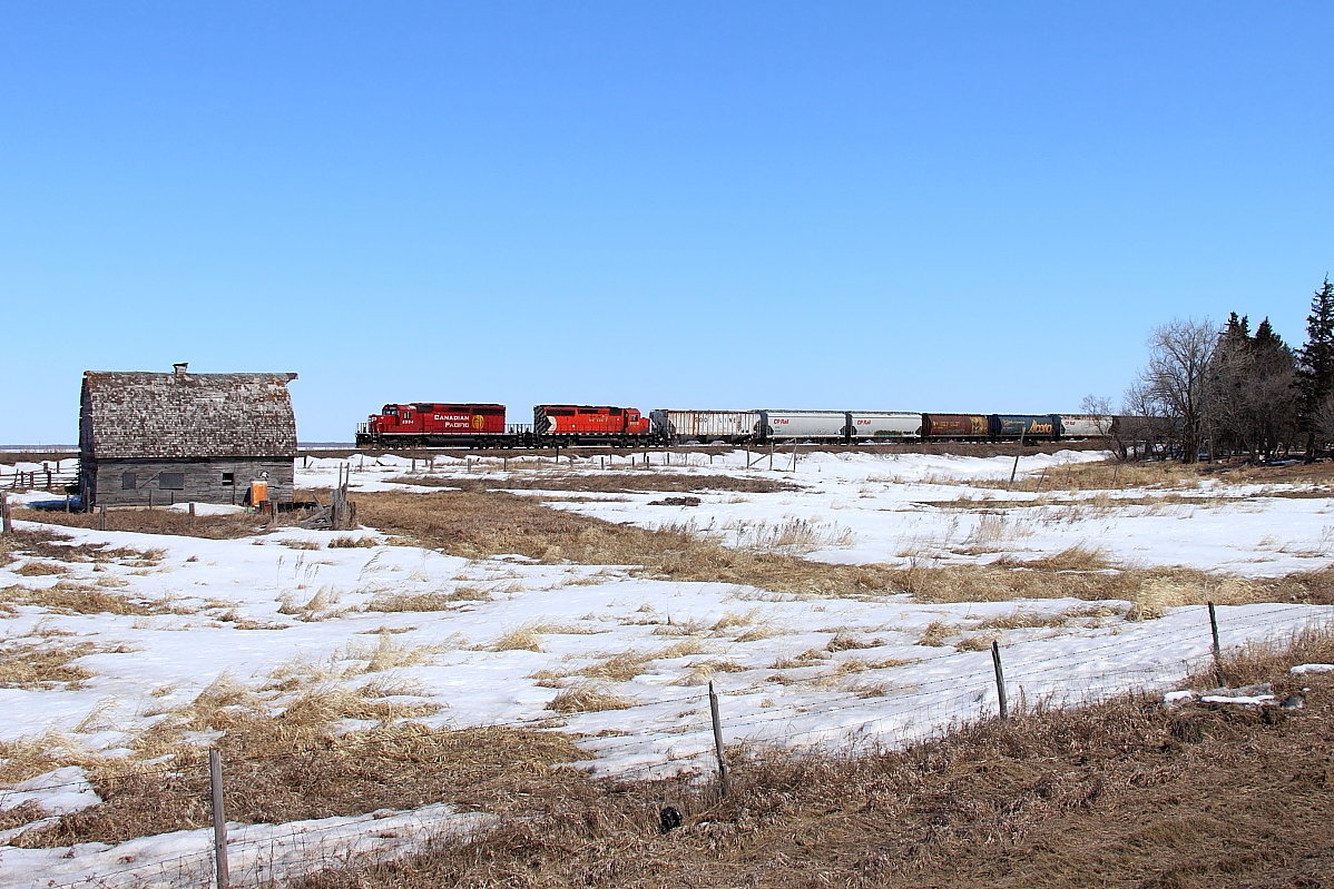 A pair of SD40-2s lead 411 past the old farm at Esmond.