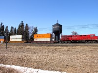 An eastbound intermodal passes the water tower in Carberry.