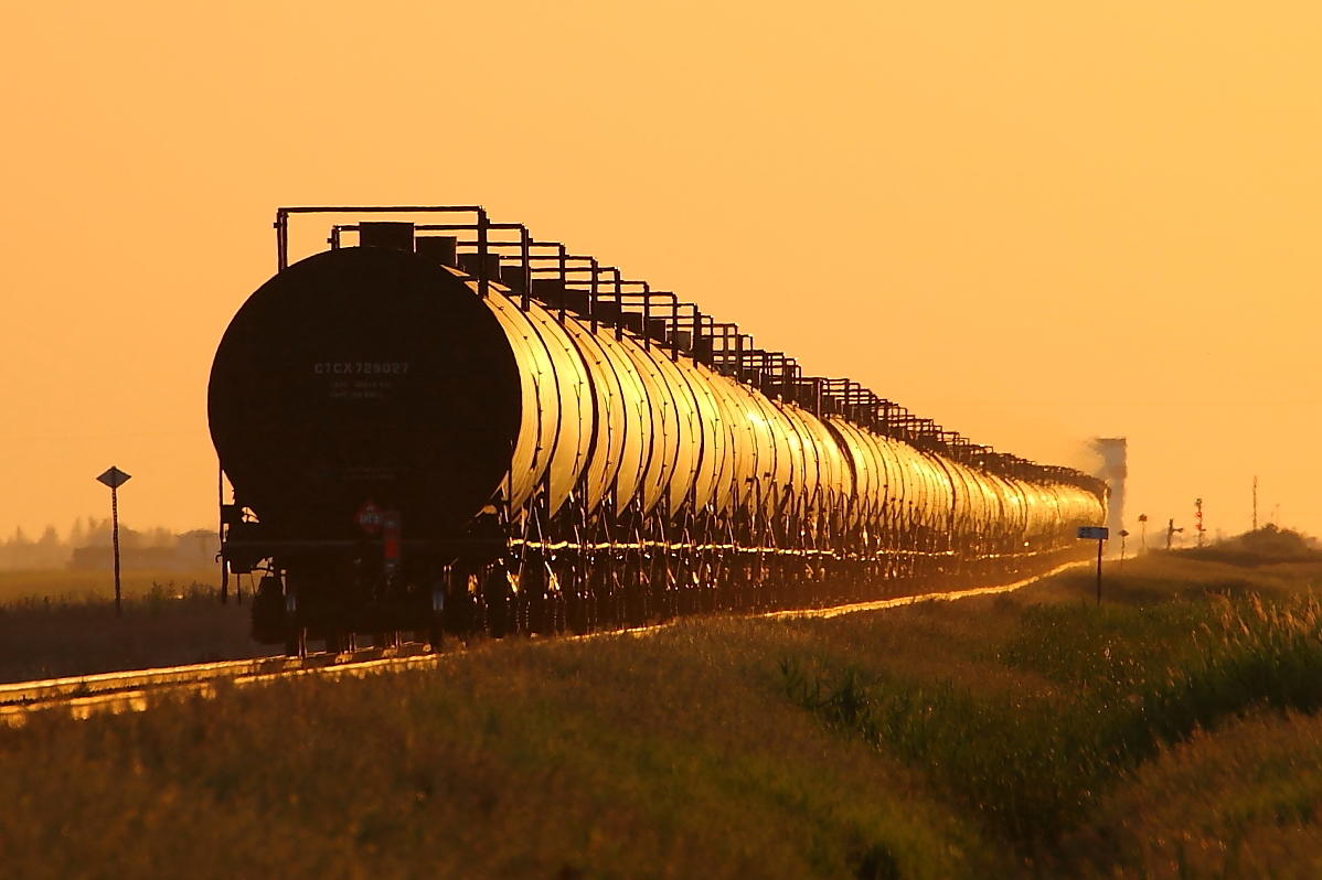 Crude oil empties head west at sunset.