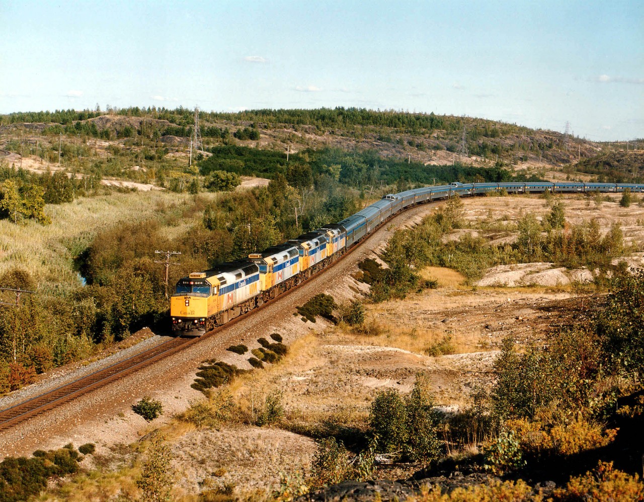 On the beautiful afternoon of Sept. 17, 2002 VIA #1 with VIA 6414, 6419, 6434 and 6454 with a very long train approach the Coniston crossing of CP-OVR Cartier subdivision heading Northwest.