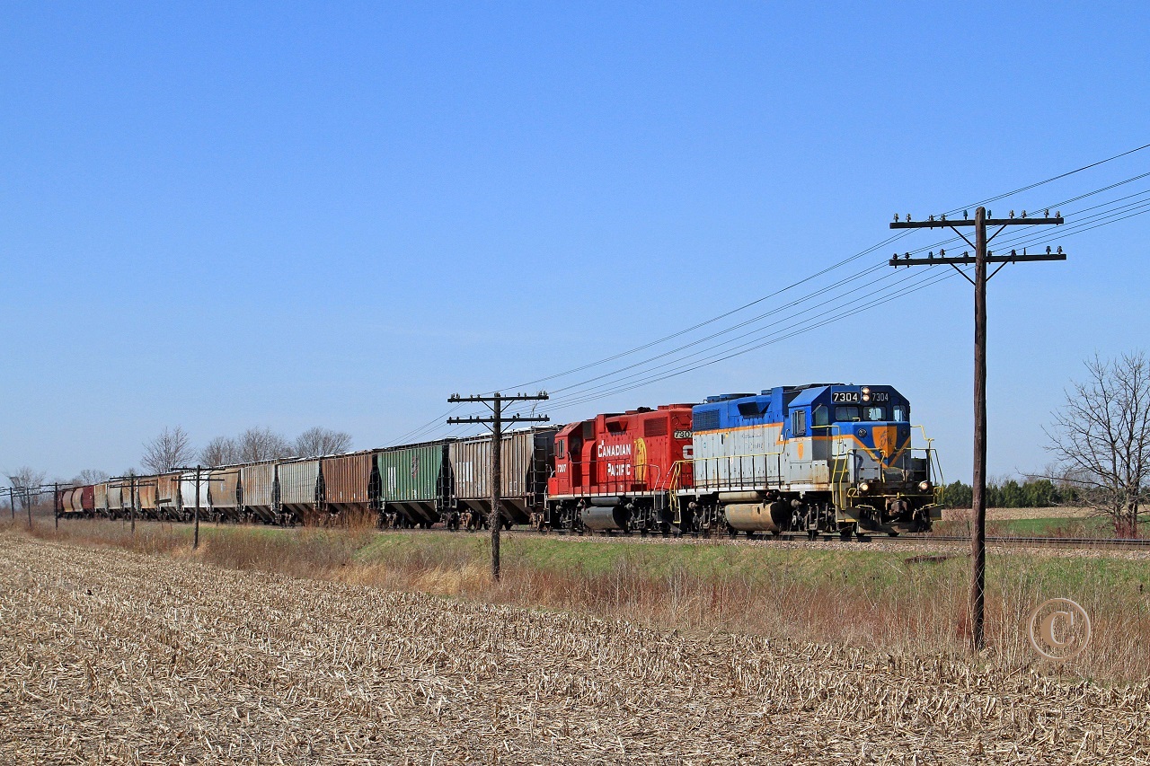 Approaching the west switch at Kent Bridge, D&H 7304 with CP 7307 lead train T76 eastward at mile 56.91 on the CP's Windsor Sub. Going into the siding ahead of T76 is CP 8831-254 where they will wait for westbound CP 9623-243. T76 will complete switching duties at the Kent Bridge mill upon departure of 254.