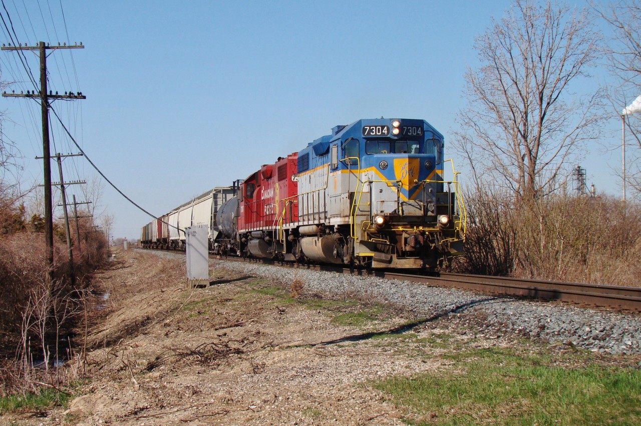 With the sun shinning brightly and a beautiful leader on T76 I had to chase this guy. Here the local has just finished up switching Greenfield Ethanol (to the right) and will head east to switch other various spots along the Windsor sub.