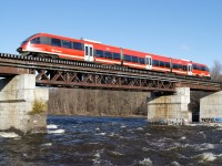In the final week before a 16 week shutdown to prepare for the arrival of new trains and a doubling in service levels, OC Transpo (Capital Railway) C3 crosses the raging Rideau River after departing Carleton Station at Carleton University.
