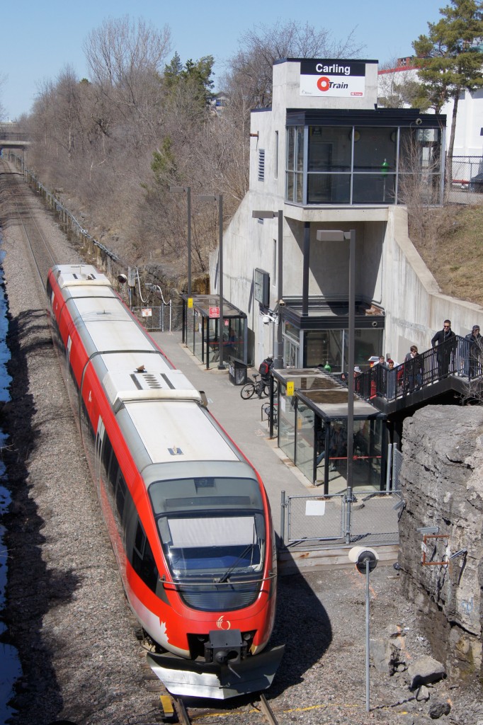 Passengers hurry to enter Carling Station to board OC Transpo (Capital Railway) C2 for a trip north to Bayview Station. The following Sunday, OC Transpo would shut down the O-Train for 16 weeks to install two passing sidings in anticipation of doubling service levels in 2014 once new trains from Alstom arrive.