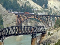 The south-bound Rocky Mountaineer headed by GP40-2(W) 8015 and an unidentified CP helper crosses the Frazer River at Cisco.