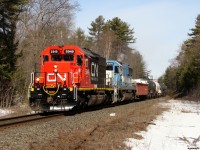 CN X31431 06 - GTW 5949 South sporting a fresh repaint barely a month old has just come back onto the mainland from Wanilah Island, with the tail end of their 86 car train still on Bala Bay Park Island. Making good time now, but running at .08 horsepower per ton, they'll only enjoy trackspeed for another 60 miles or so before running into some tough grades before terminating at Mac Yard. 