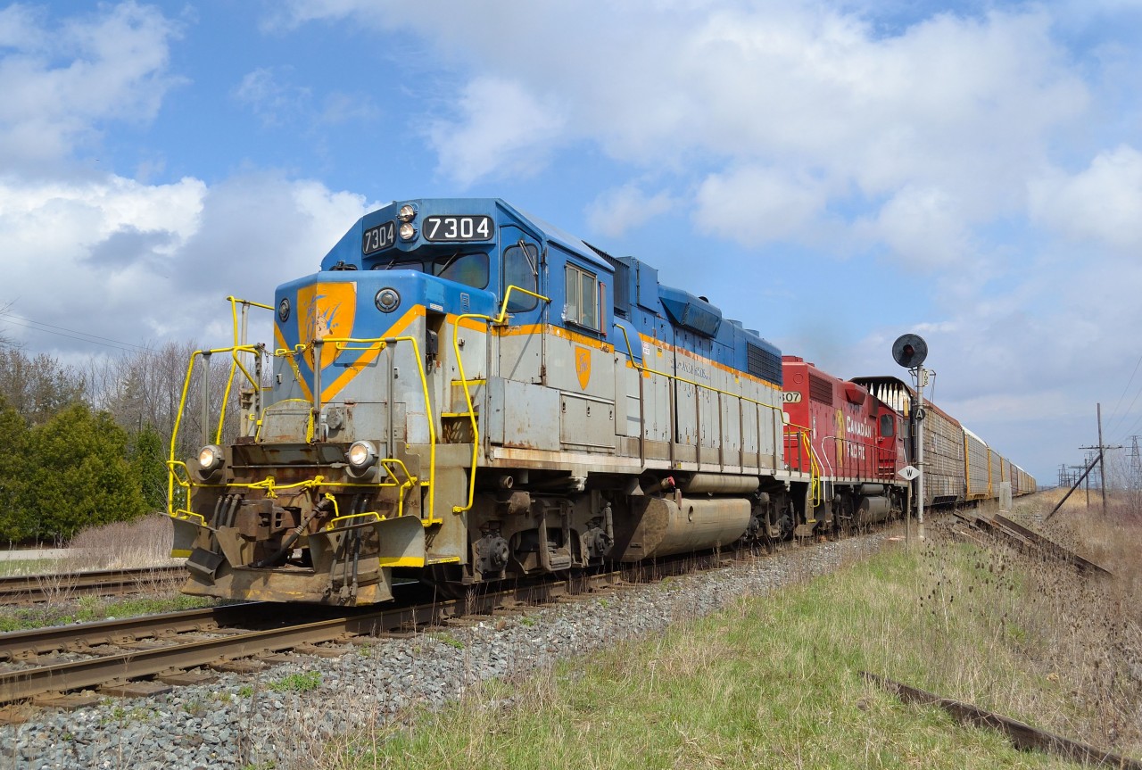 CP T76 led by D&H 7304 speed past the east siding switch here in Tilbury on its way back to Walkerville. This was my 1st opportunity to shoot this loco heading westbound and leading. The sun worked in my favor and peeked out about 30 seconds before the train arrived and allowed me to "nail" the shot :)