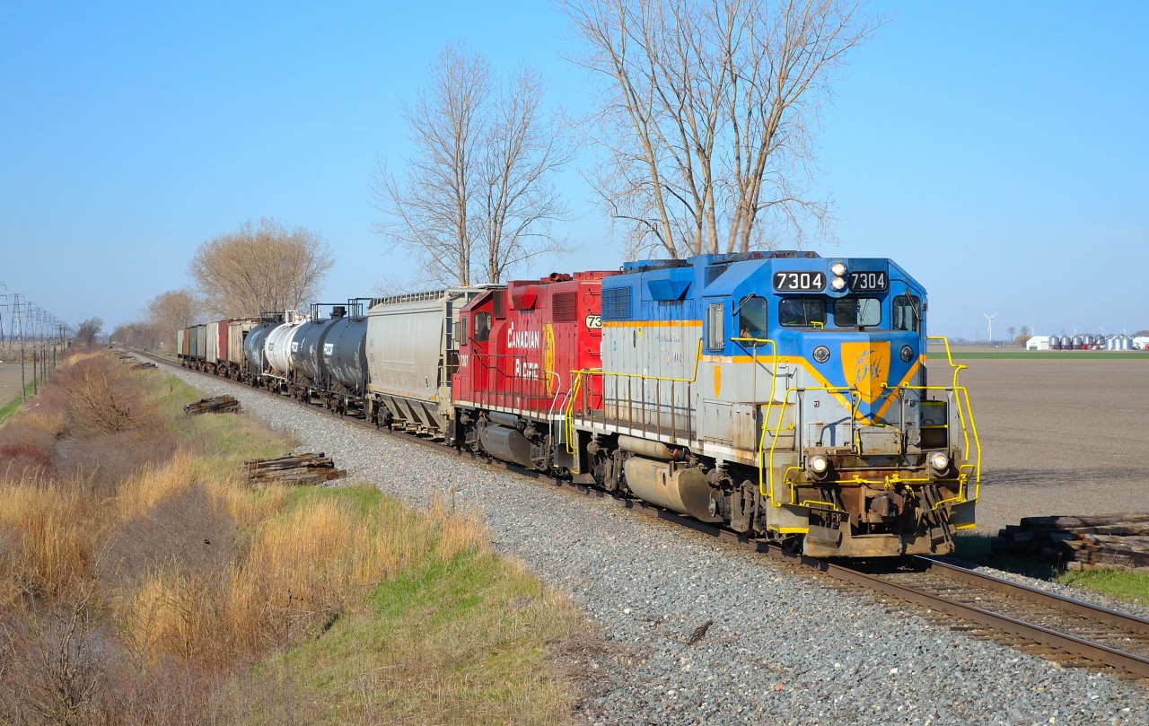 CP T76 led by D&H 7304 passes eastbound thru Jeannette mile on a beautiful sunny morning.