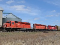 CP 235 heads westbound by the grain elevator at Haycroft with a trio of EMD SD40-2's