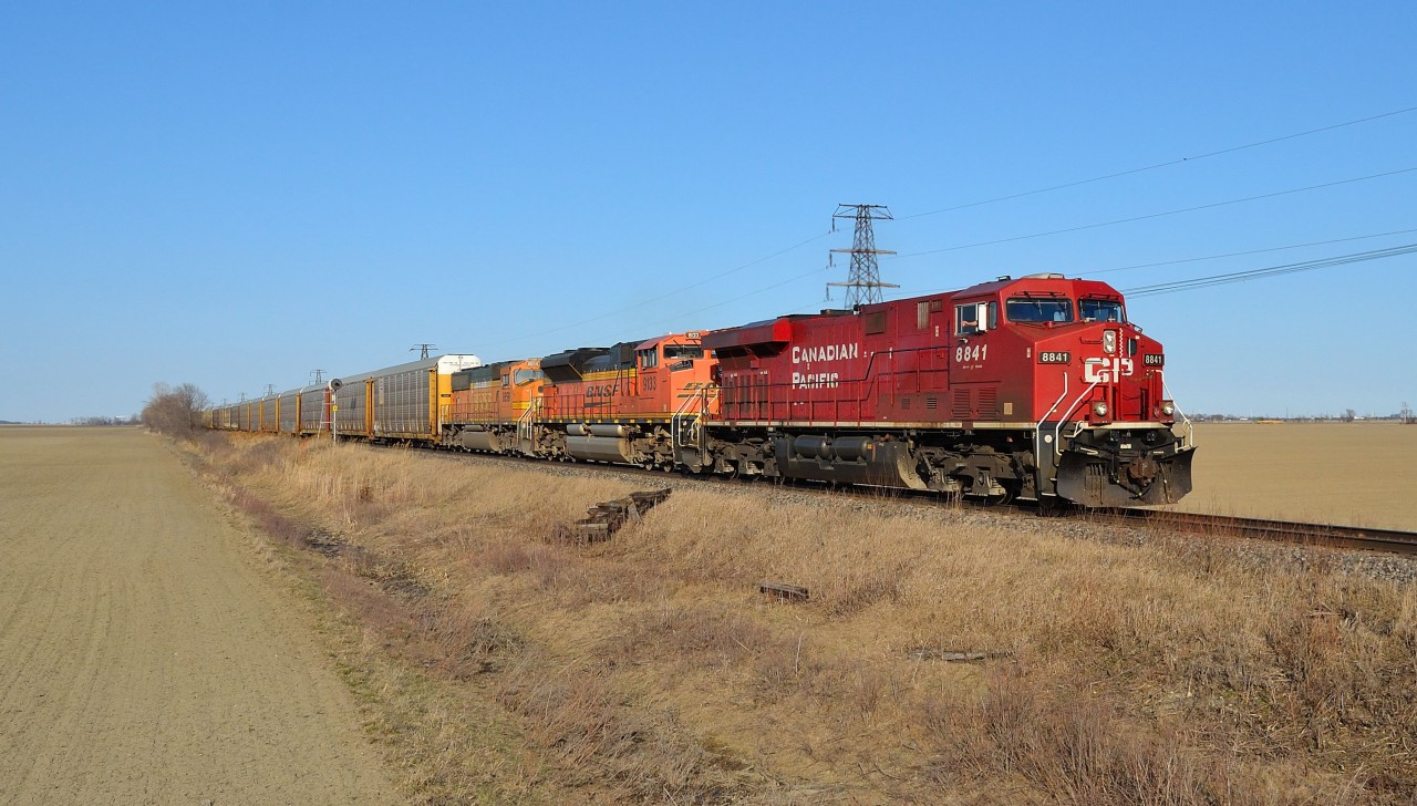 CP 147 heads westbound approaching Tilbury led by CP 8841, BNSF 9133 & BNSF 8859. This same power was on an eastbound 608 crude oil train the day before.