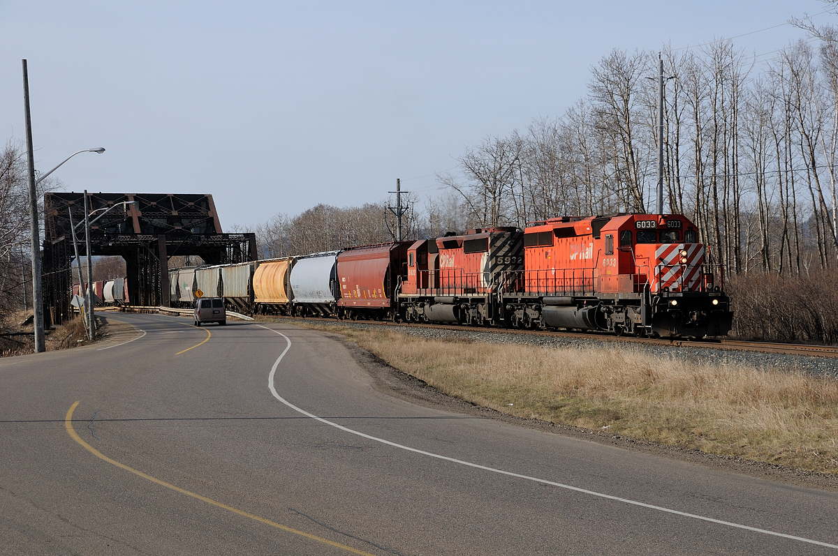 The 7 o'clock Roust pulls a train of potash loads over to TBTL (Thunder Bay Terminals Ltd.). Seen here, CP SD40-2's 6033-5932 pull the train between Mission and McKellar Islands.