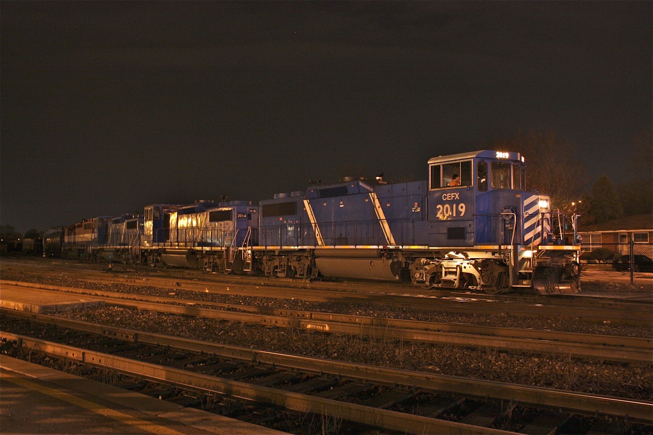 Garnet bound SOR train with 3 GP20Ds and a GP40 prepare double their train and depart Brantford yard after the passage of CN train #397 and the rail grinder in the wee morning hours.