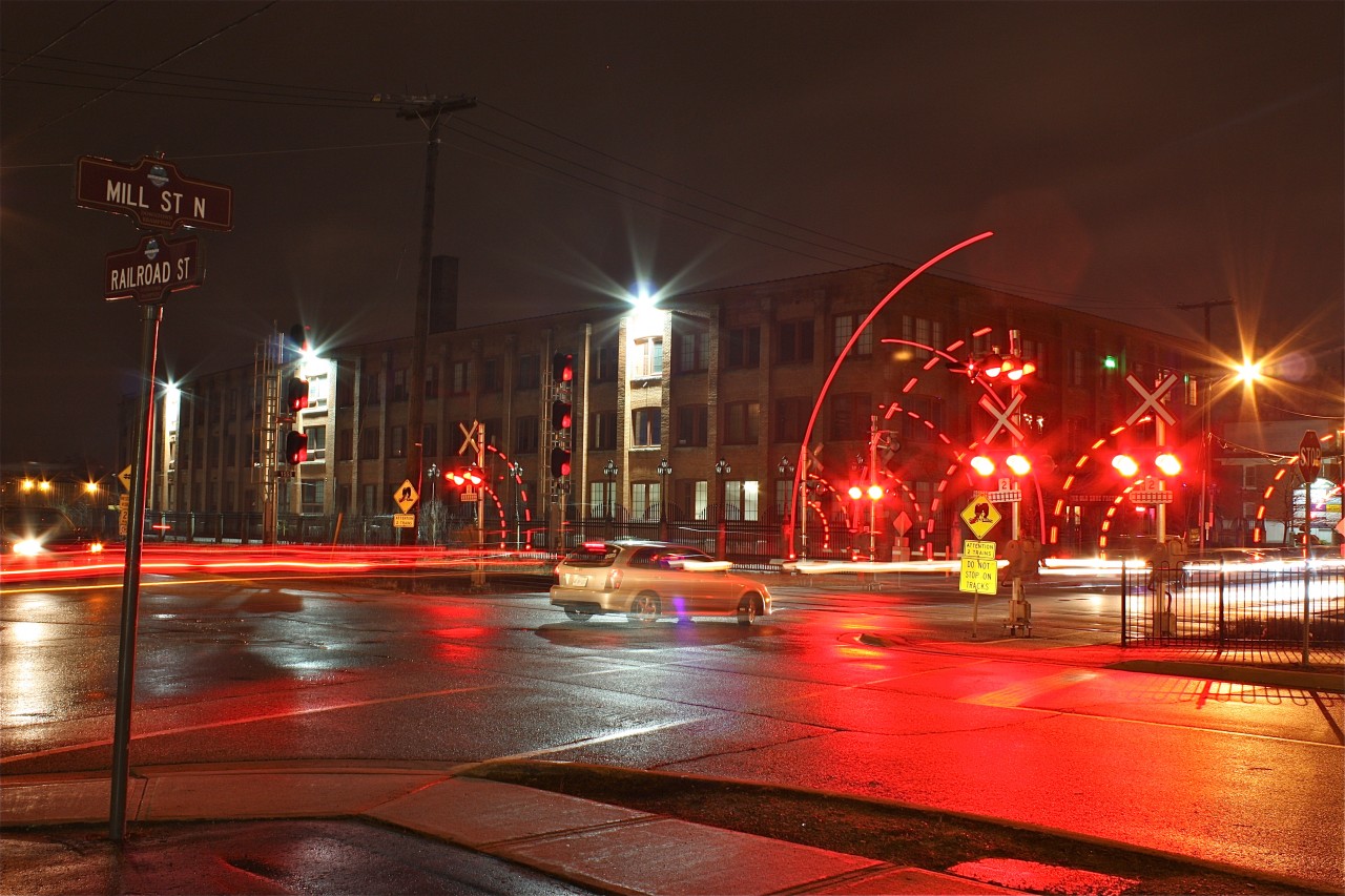 A CN westbound clears the crossing at Railroad and Mill St. creating a nice light show.