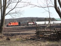 The days OSR southbound train is returning back to Guelph Jct. from Guelph as it passes south of Corwhin. The area was ravaged by an ice storm the previous week, which downed a number of trees, while in the field the scares remain from a large grass fire set a few days earlier. 