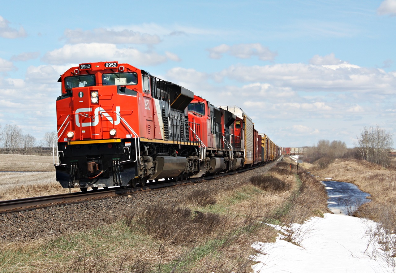 A fresh 8952 with a Mexican sticker between the numberboards takes 347 west at Code siding which is west of Gerald Saskatchewan.