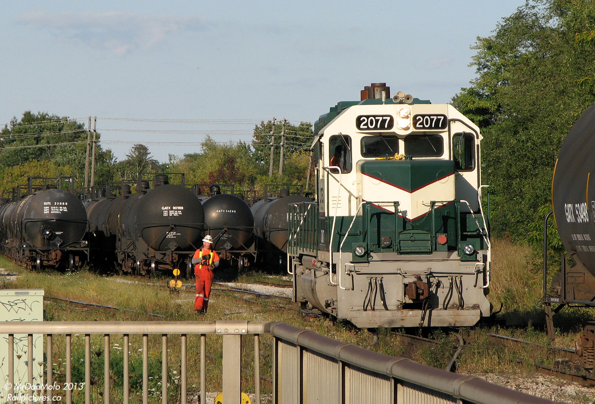 A RailServe crew is busy switching tank cars of crude oil in Clarkson Yard, for the nearby Petro Canada refinery. LTEX GP38 2077 is the power of the day, one of two units stationed at the plant for switching inside and moving cars between there and here, where they are lifted and set of by CN locals along the Oakville Sub.