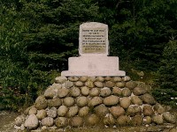 The last spike on the North Shore section between Montreal and Winnipeg was driven at Noslo, just west of Jackfish, Ontario, on 16 May 1885. Colonel Oswald, of the Montreal Light Infantry, hammered home the last spike. He was on a troop train travelling home from the Riel rebellion. Fifty years later, on May 16, 1935, a few of the original workers and veterans of the CPR, re-enacted the driving of the last spike at Noslo. A stone cairn and cement monument commemorate the site. 
The site is quite remote. The cairn is located on the north side of the track at mileage 102.7, well over 4 miles from the siding at Jackfish. 
