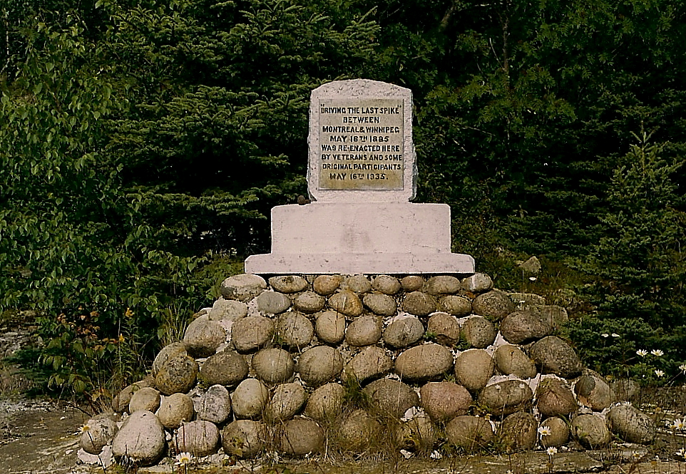 The last spike on the North Shore section between Montreal and Winnipeg was driven at Noslo, just west of Jackfish, Ontario, on 16 May 1885. Colonel Oswald, of the Montreal Light Infantry, hammered home the last spike. He was on a troop train travelling home from the Riel rebellion. Fifty years later, on May 16, 1935, a few of the original workers and veterans of the CPR, re-enacted the driving of the last spike at Noslo. A stone cairn and cement monument commemorate the site. 
The site is quite remote. The cairn is located on the north side of the track at mileage 102.7, well over 4 miles from the siding at Jackfish.