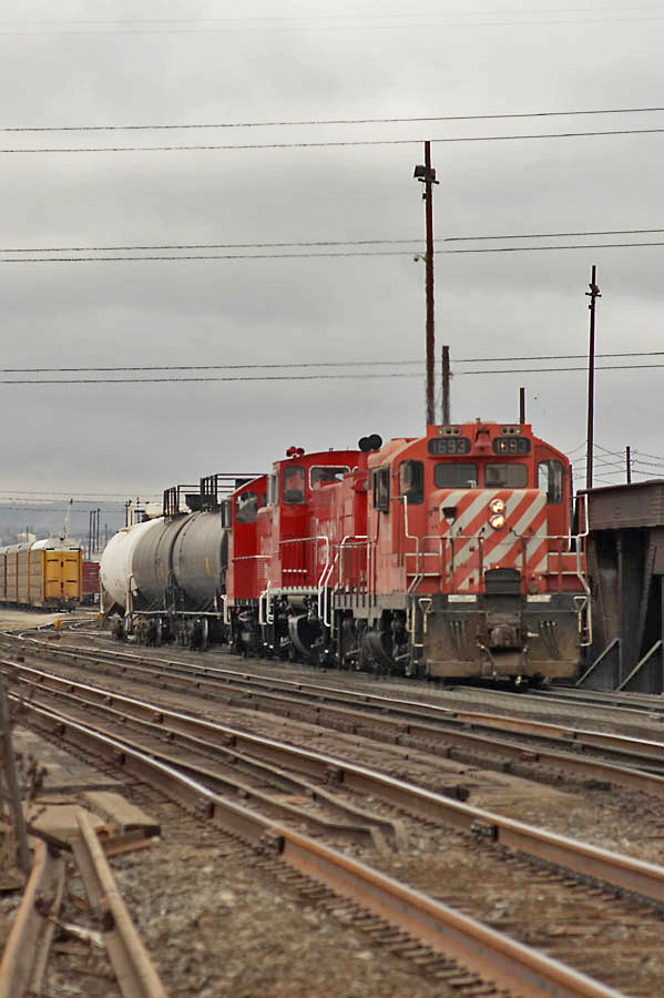 I don't know if the power coordinater was playing an April Fools prank on the pulldown crew but I sure do like the consist! A GP9u/MP15/SW1200RS set await the next move on the south end of CP's Alyth Yard.
