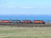 <b>650 feet</b> is the height of the Niagara Escarpment at Vinemount, Ontario and four 645's are groaning in protest as train 640 has nearly finished the climb.  At 650 feet high one can see many things in the background - Lake Ontario for one -  in front of the Lake is Stoney Creek, and in the background Burlington and Oakville, Ontario. 
<br><br>
The suggested photos below will show many TH&B and CP photographs from other great photographers over the years.