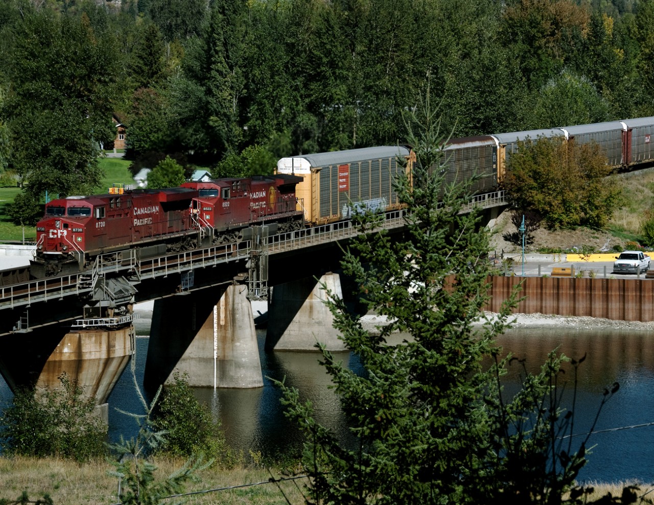 Westbound 199 with several auto racks crosses the swing bridge over the Narrows between Mara and Shuswap Lakes at Sicamous. The bridge is operational and is opened frequently for recreational boats such as house and sail boats.