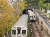 Heading to Davisville Subway Station, a train of northbound T1 subway cars has just passed a southbound train of older H5's heading into the tunnel. Shot from the old CNR Beltline Bridge (once used to deliver Toronto's first subway cars in the 50's, now long abandoned as a railway corridor and currently a walking trail), part of the Davisville Yards can be seen on the right, to the left Yonge St. and the sprawling office towers north of Bloor.