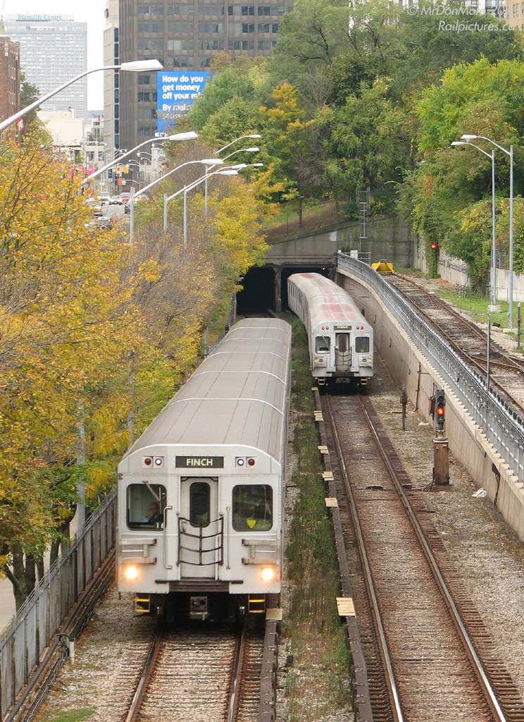 Heading to Davisville Subway Station, a train of northbound T1 subway cars has just passed a southbound train of older H5's heading into the tunnel. Shot from the old CNR Beltline Bridge (once used to deliver Toronto's first subway cars in the 50's, now long abandoned as a railway corridor and currently a walking trail), part of the Davisville Yards can be seen on the right, to the left Yonge St. and the sprawling office towers north of Bloor.