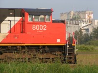 Almost new SD70M-2 CN 8002 poses on track TC 92 at the Thunder Bay North yard. In the background Saskatchewan Pool Elevators 7A and 7B fill the skyline in the Intercity area at Thunder Bay.   