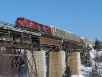 CP train 119 led by a pair of GE’s -  8833 and 9553  - are midway across the Nipigon River on a combination of deck truss, plate girder and steel beam floor spans.