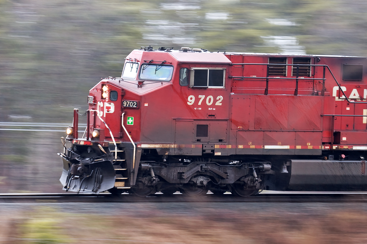 Panned westbound in freezing rain. Nice look at the steerable truck.