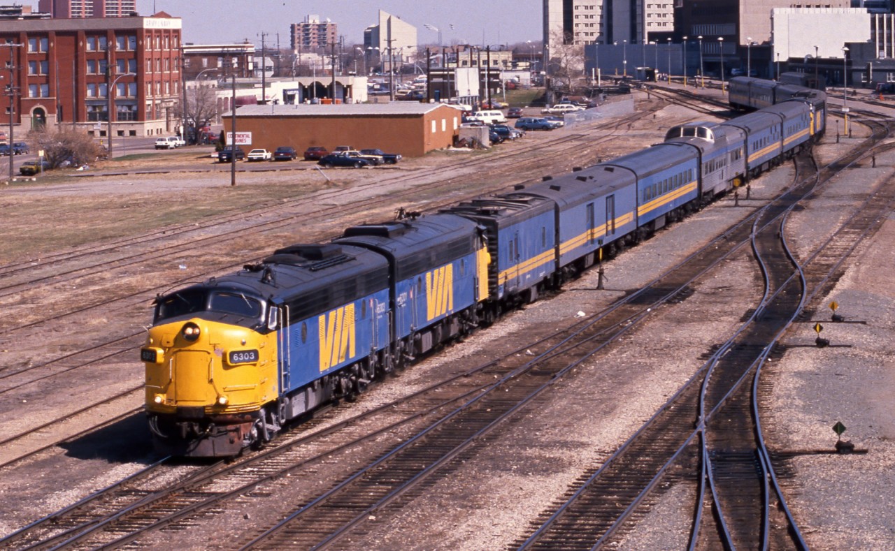 In May 1989 the VIA "Supercontinental" departs Edmonton behind FP9A's 6303 and 6301.  Attached to the rear is the "Skeena" behind VIA 6310.  This scene can never be repeated as these tracks, originally laid by Canadian Northern in 1905, have since been lifted and a community college, casino and parking lot occupy the old rail yard site.  The shot was taken from the 105th Street overpass, also now a piece of history.