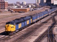 In May 1989 the VIA "Supercontinental" departs Edmonton behind FP9A's 6303 and 6301.  Attached to the rear is the "Skeena" behind VIA 6310.  This scene can never be repeated as these tracks, originally laid by Canadian Northern in 1905, have since been lifted and a community college, casino and parking lot occupy the old rail yard site.  The shot was taken from the 105th Street overpass, also now a piece of history. 