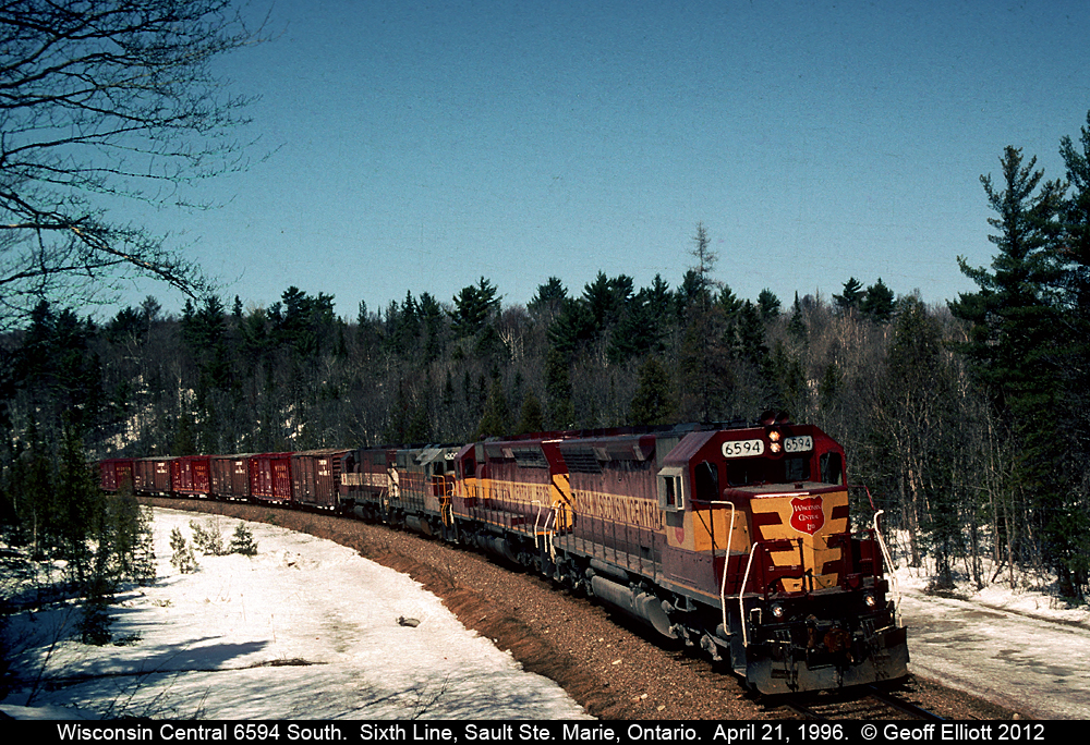 WC SD45 6594 leads a southbound freight around the curve at Sixth Line, just north of Sault Ste. Marie, Ontario.  In the consist are another SD45, Algoma Central GP38-2, and a WC SDL39!