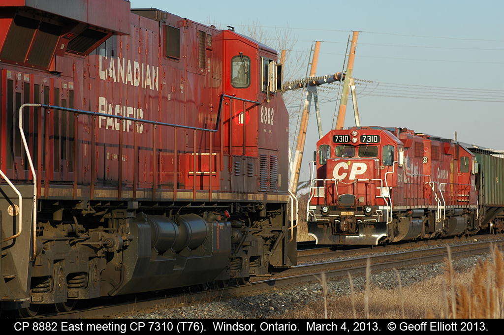 T76, with CP 7310, sits tied up at Jefferson Ave. in Windsor as 8882 gets it's train rolling east to head out of town.
