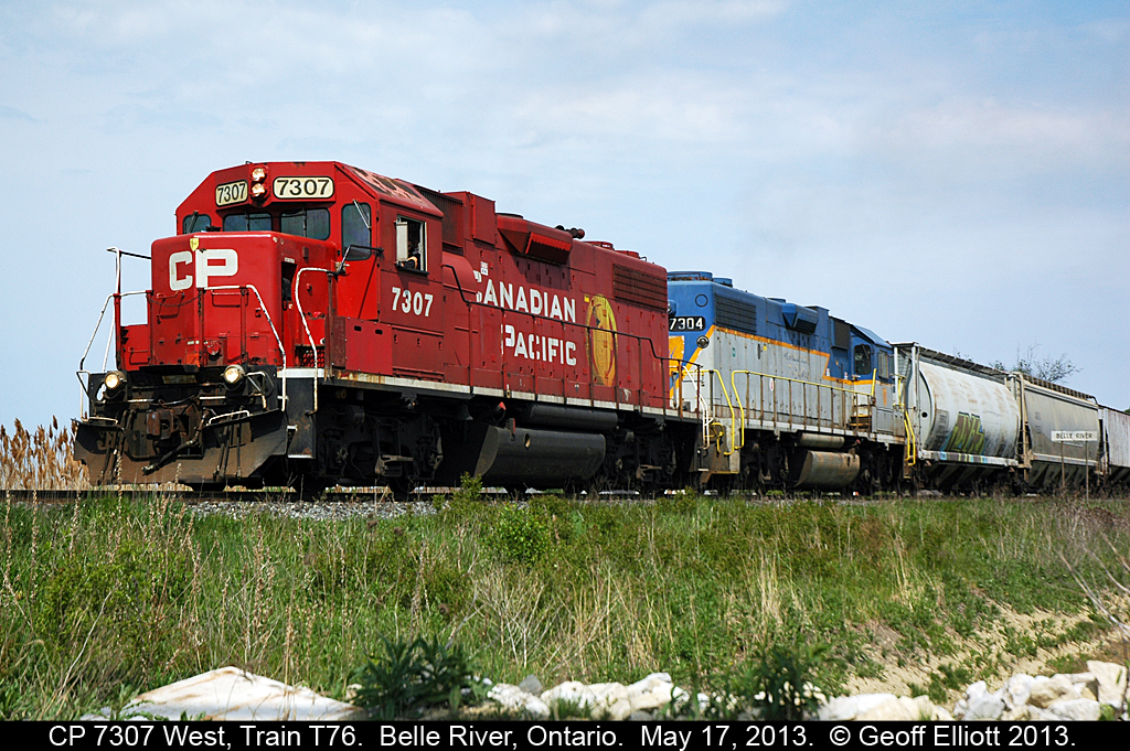 Train T76, or the 'Chatham Local' as I like to call it, are getting on it with it's pair of D&H GP38-2's (note the shield above the CP on the nose) and 2200 feet of train after meeting train 640 in Belle River shortly before.
