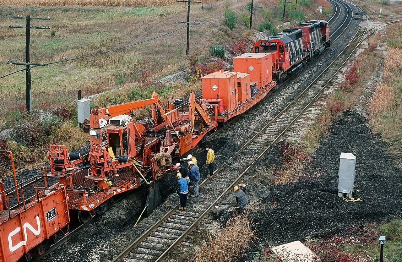 Bet you never wondered how CN's fibre optic cable got into the ground.....the Trench – Cable train is at CN Kingston Subdivision mile 304   (near Lasco Steel -   Hopkins Street ). CN plain SD-40  # 5084 is the future #6007, the other unit may be SD-40W #5339 (or ? ). October 1991 Kodachrome by S. Danko


More Kingston Subdivision


  M420W's at mile 304   


  FPA-4's at mile 292  !   


  thirty years after FPA-4's at mile 292