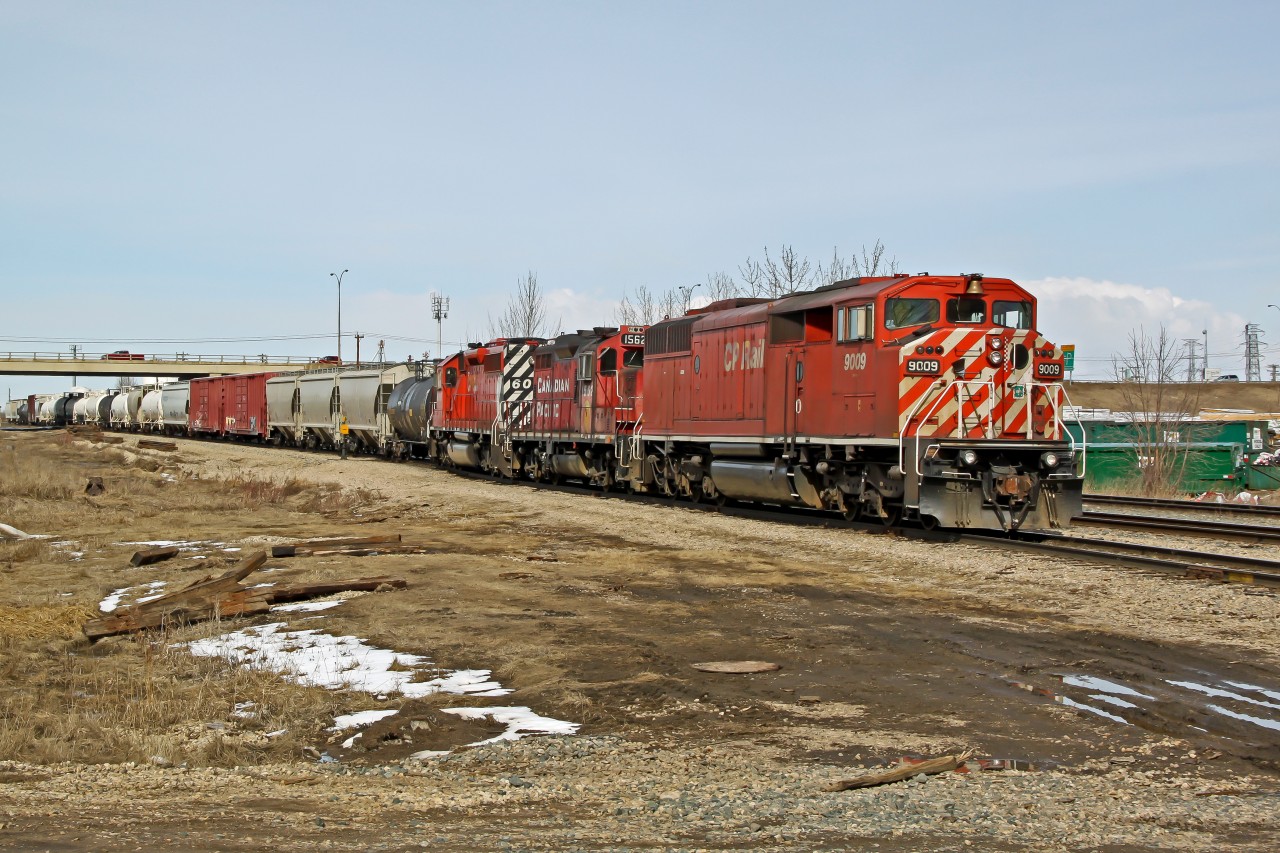 SD40-2F CP 9009, GP9u CP 1562 and SD40-2 CP 6067 wait on the CN Camrose Sub to cross back to the CP Scotford Sub with a transfer from CN's Clover Bar Yard.
