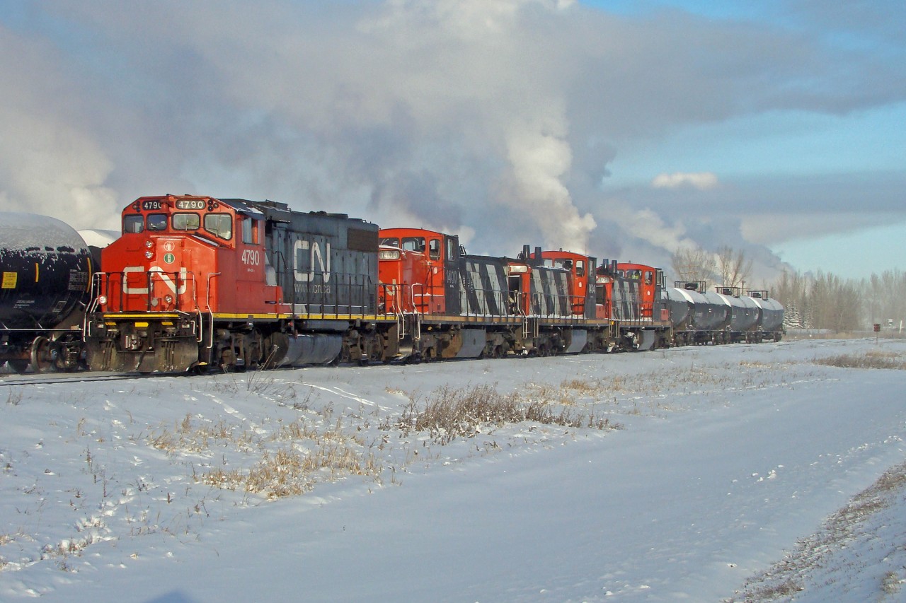 On a cold frosty New Years eve GP38-2 CN 4790 coupled with 3 GMD1's, 1400, 1434 and 1409 switch cars on the Scotford Industrial Lead at CN's Scotford Yard.