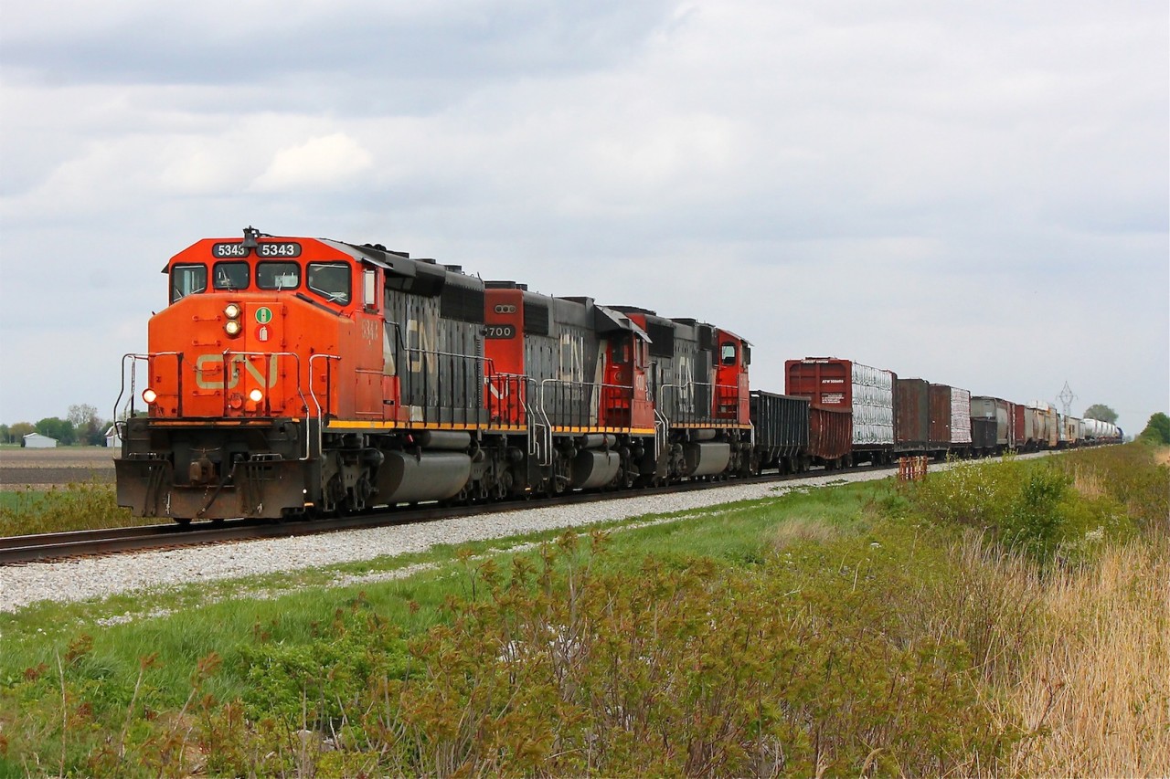 CN 439 thunders westward with a beautiful SD40-2W and dimensional load with windmill parts bringing up the back of the train. But of course the clouds had to come out just as the train approached.
