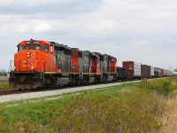 CN 439 thunders westward with a beautiful SD40-2W and dimensional load with windmill parts bringing up the back of the train. But of course the clouds had to come out just as the train approached.