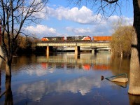 A westbound manifest crosses the Assiniboine River in downtown Winnipeg.