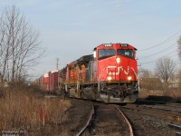 <b>The early bird gets the worm.</b>
<br><br>
As a general rule of thumb, anything worthwhile tends to show up at the darnedest times - and it's all about timing. CN #384 today had some goodies, necessitating getting trackside early on a Friday we would have otherwise slept in for. Someone in London or Sarnia would have had to get up in the wee hours of the morning under darkness, but since our photo spot is near the end of this train's run, we only had to get downtown just at the end of morning rush hours.
<br><br>
As luck would have it #384 wasn't early or late this morning, and it rolled into town just before 9am with CN 2658 leading Burlington Northern Santa Fe 5424, Wisconsin Central "Flag livery" 3027, and a grey KCS-painted Grand Trunk Western 5944, seen here crossing Fletchers' Creek west of downtown Brampton.
<br><br>
The track in the foreground that appears to lead off to the photographer curved south to service Georgia Pacific on Queen Street. Known as the "Dixie Cup Spur", it was taken out of service with the triple-tracking of the corridor in 2008/2009, never reconnected, and eventually ripped out in April 2013. (Photo of it in service can be seen <a href=http://www.railpictures.ca/?attachment_id=3744>*here*</a>).