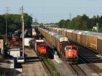 CN 399 pulls down track 34 past the yard crew at Aldershot yard. 399's consist included CN 5687, BC Rail 4646 and an idle 5703. 399's crew would set off 53 emtpy autoracks from Edmonton's Clover Bar yard destind for the Ford Oakville plant. They then picked up a dozen autoracks from the adjacent string and headed west.  
