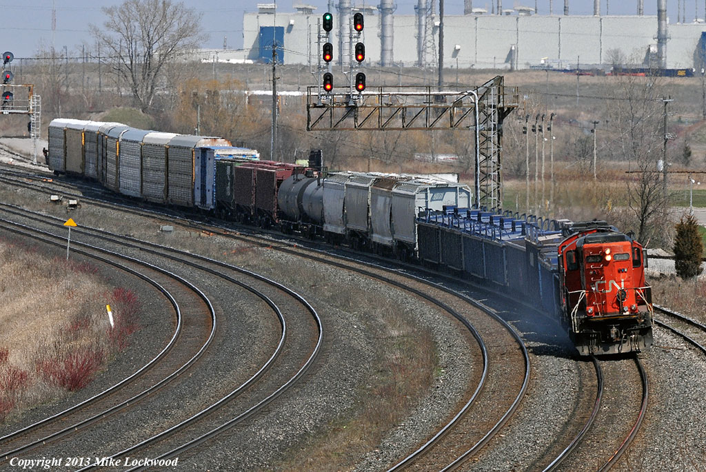 Almost looks like an un-rebuilt GP9 is powering this train... almost. CN 7075 and 7082 with 571's Belleville-Mac Yard train work the yard at Oshawa. 1421hrs.